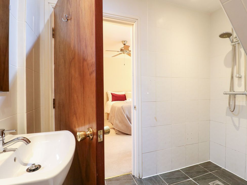 A bathroom with a sink and shower at Hambleton House in Castle Donington