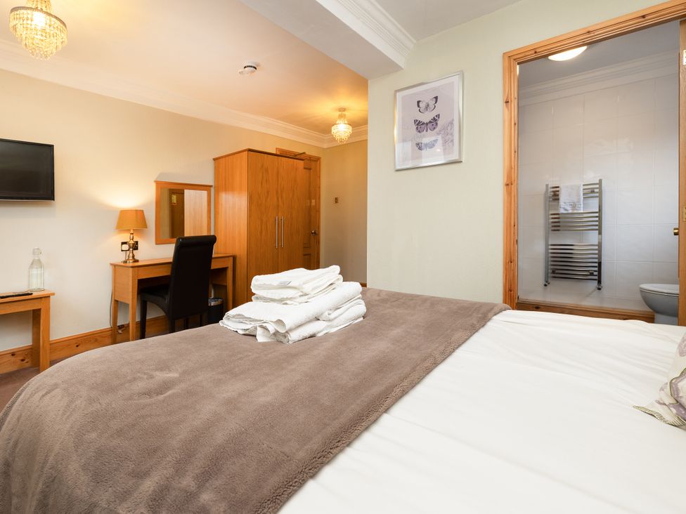 A bedroom with a bed and furniture at Hambleton House in Castle Donington