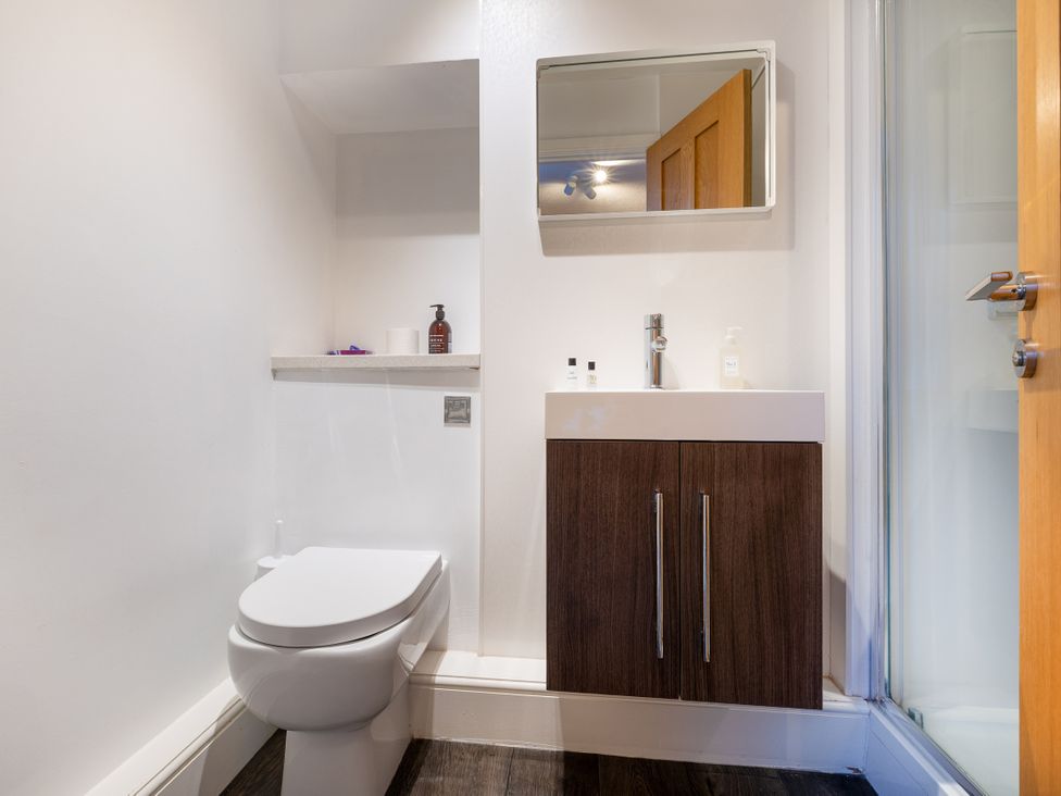 A bathroom with a toilet and sink at Hambleton House in Castle Donington