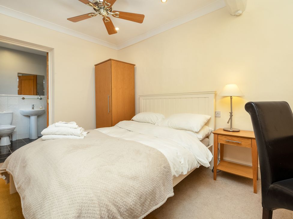 A bedroom with a bed and a nightstand at Hambleton House in Castle Donington