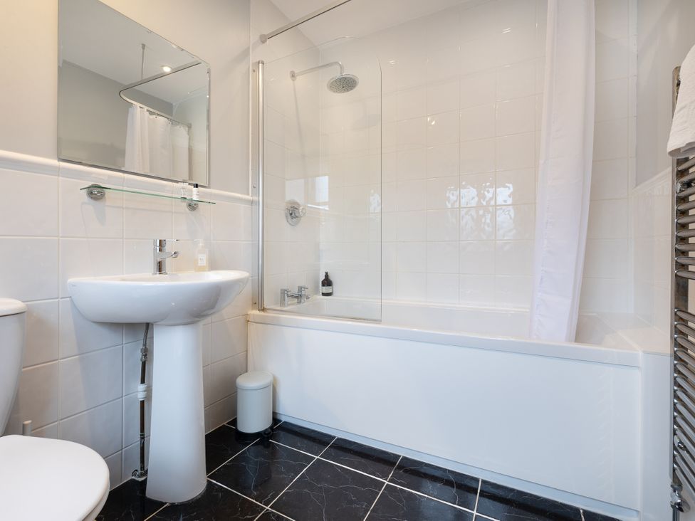 A bathroom with a sink and bathtub at Hambleton House in Castle Donington