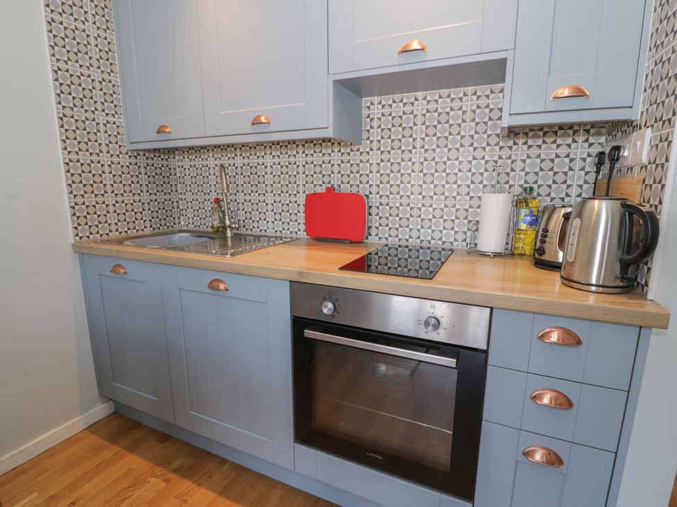 A kitchen with a sink and cooker at 56C South Snowdon Wharf Porthmadog