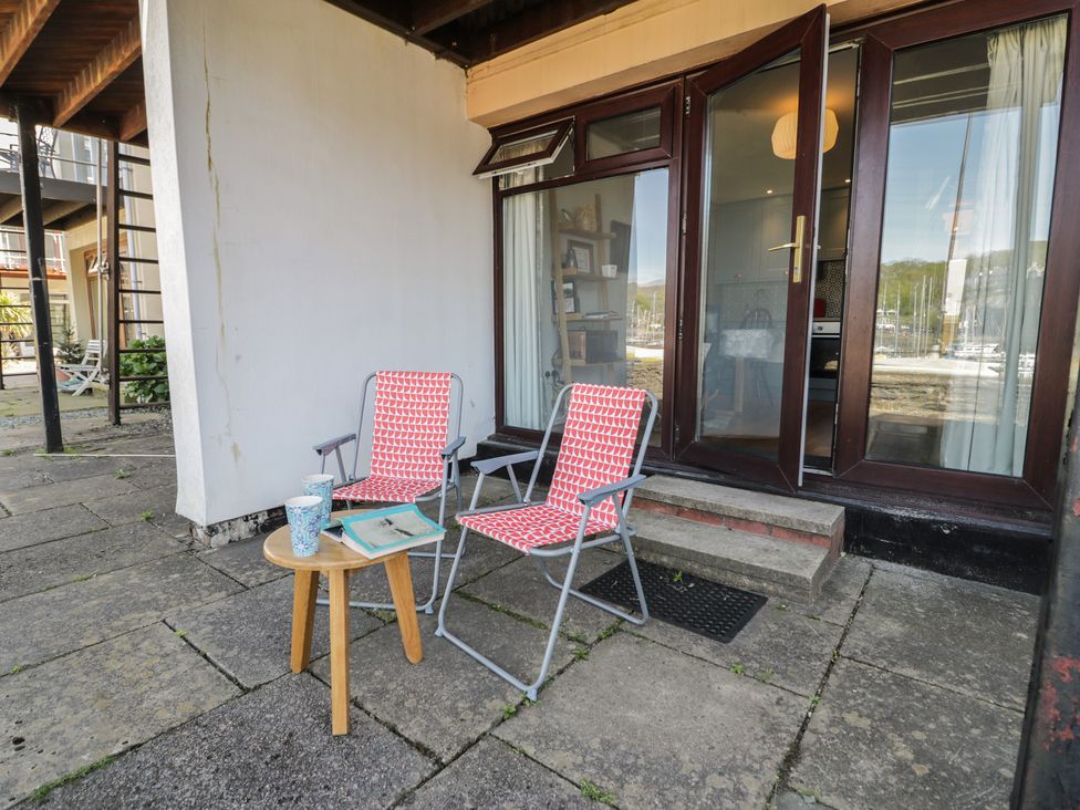 A patio with chairs and a table at 56C South Snowdon Wharf in Porthmadog
