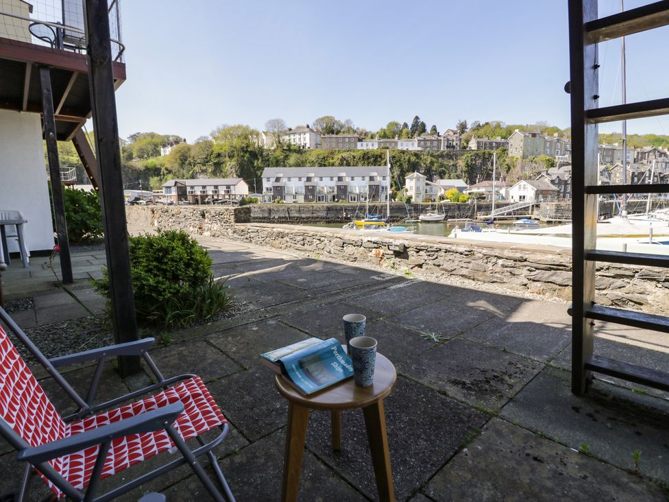 An outdoor seating area with a table and cups at 56C South Snowdon Wharf in Porthmadog