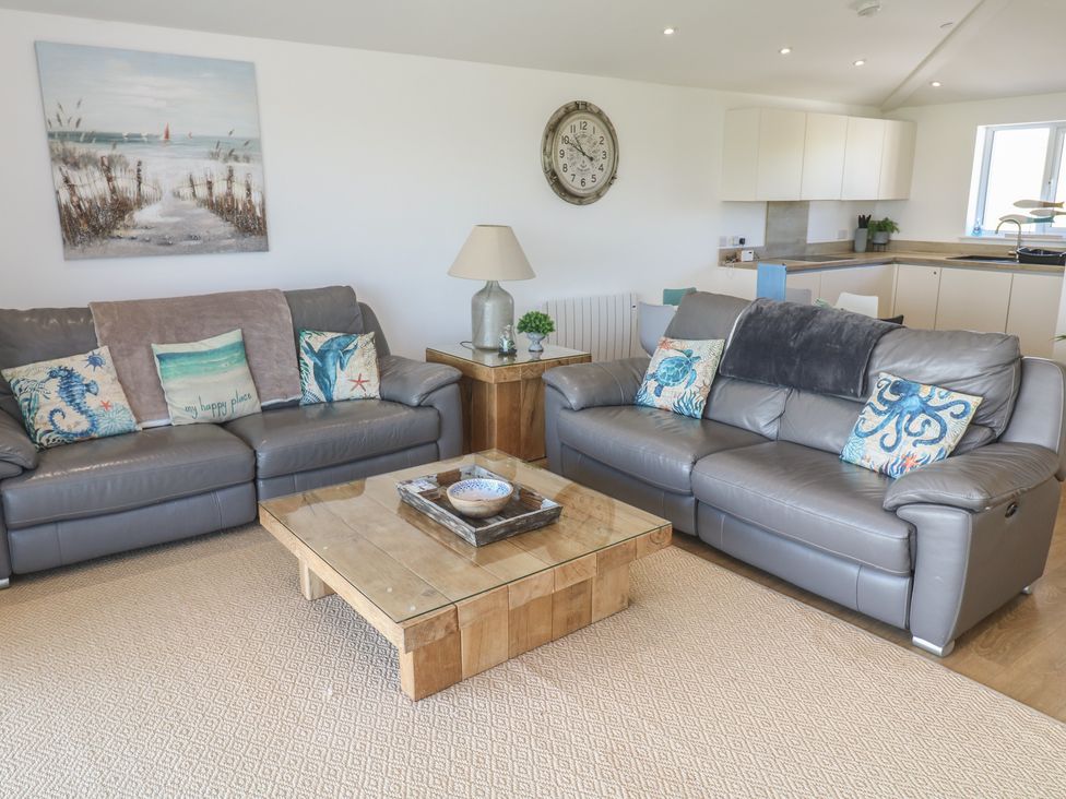 A living room with two sofas and a coffee table at Sandpiper in Perranporth