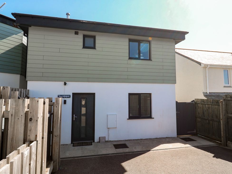 An exterior view of a house with a door and windows at Sandpiper in Perranporth