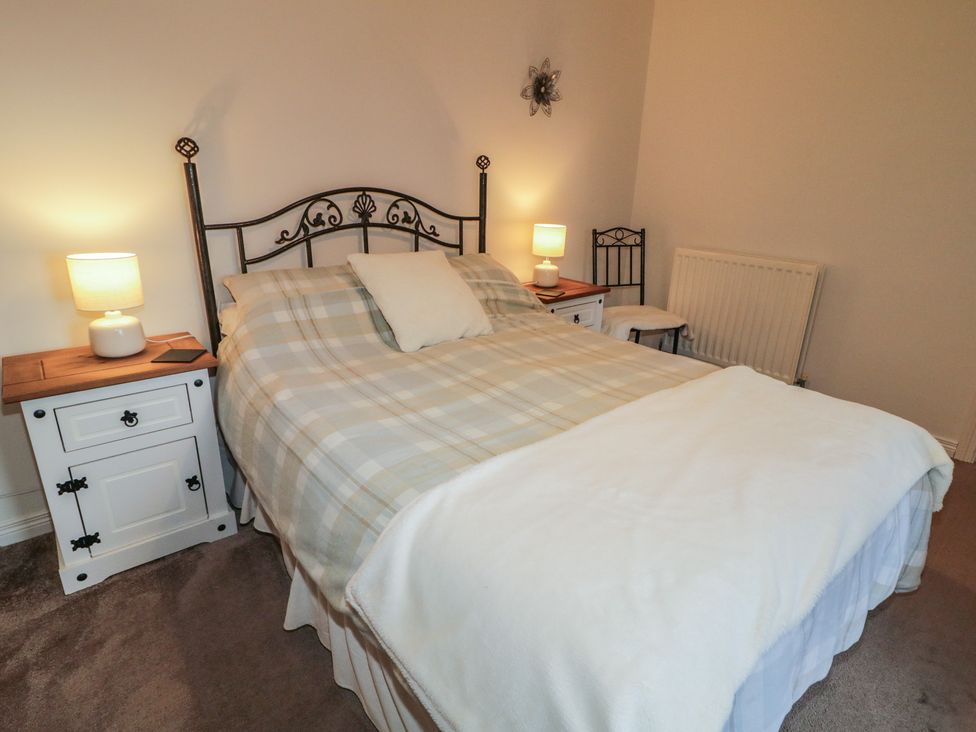 A bedroom with a bed and bedside tables at Shaws Hill Farmhouse, Kells, County Antrim