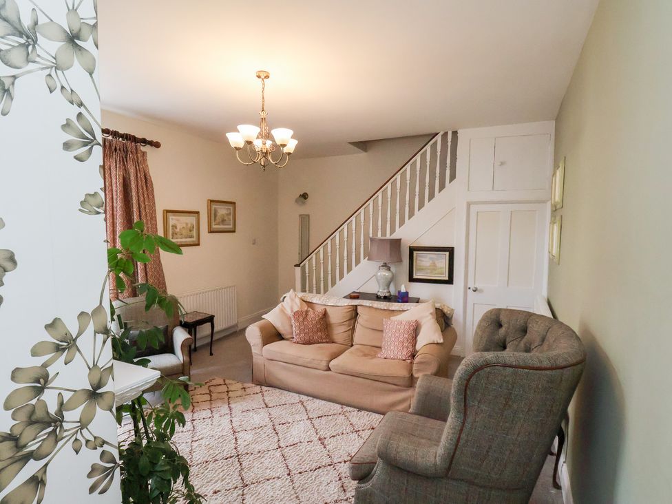 A living room with a sofa and armchair at 20A St Hilda's in Whitby