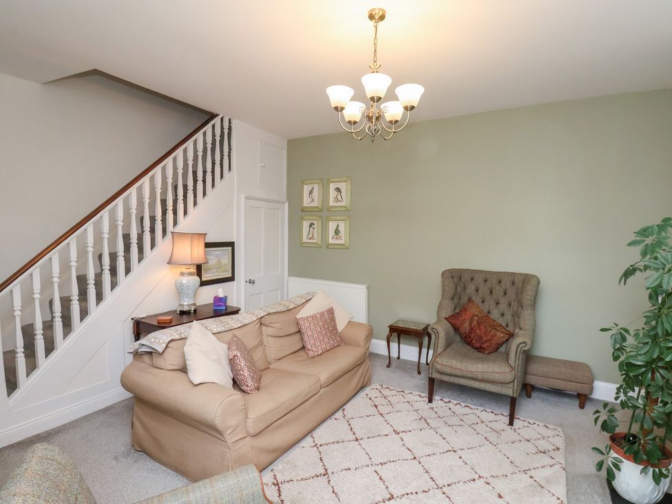 A living room with a sofa and armchair at 20A St Hilda's in Whitby