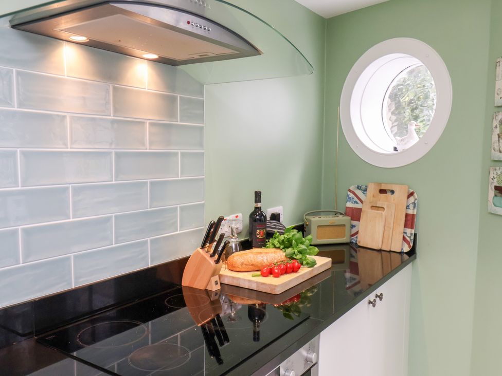 A kitchen with a black countertop and food preparation area at 20A St Hilda's in Whitby