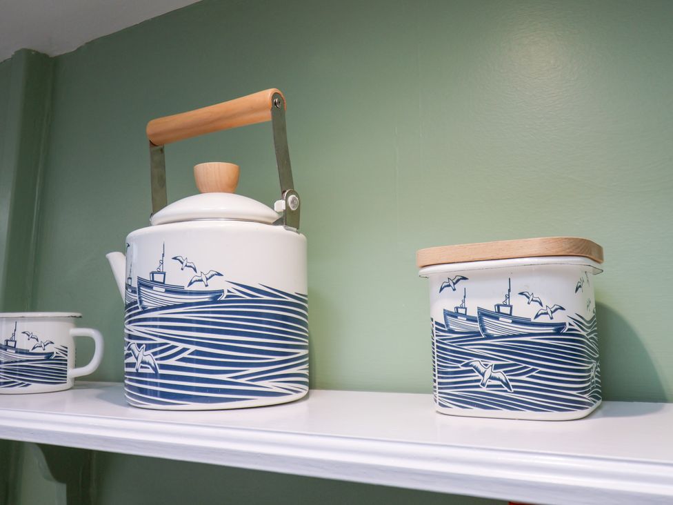 A kettle and container on a shelf at 20A St Hilda's, Whitby