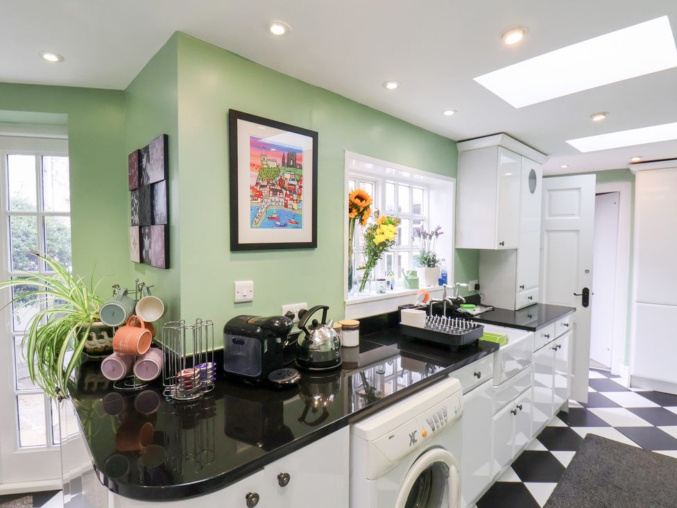 A kitchen with appliances and a window at 20A St Hilda's in Whitby
