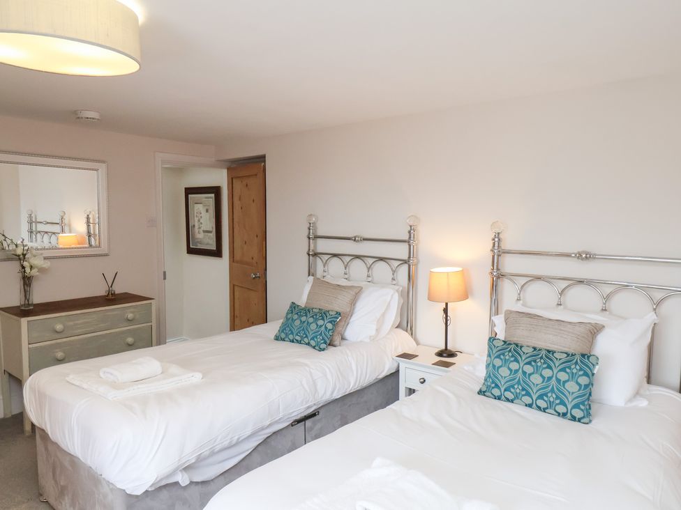 A bedroom with two beds and a dresser at 20A St Hilda's in Whitby