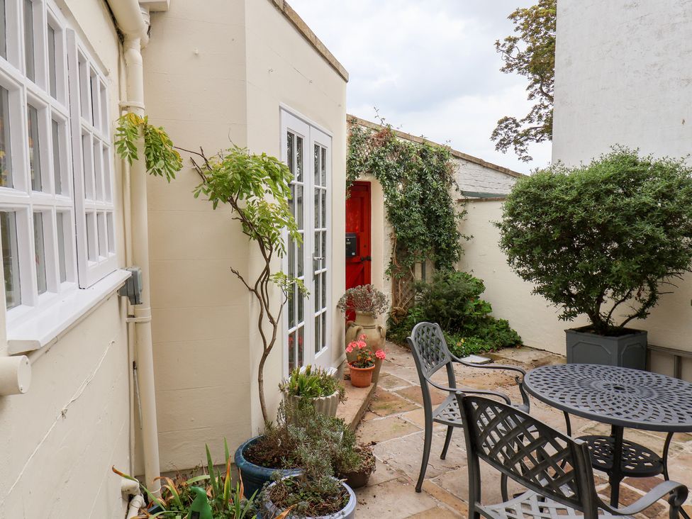 A garden space with a table and chairs at 20A St Hilda's in Whitby