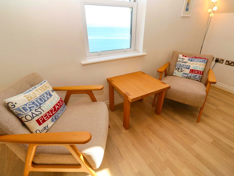 A living room with two armchairs and a coffee table at Meridian in Carbis Bay