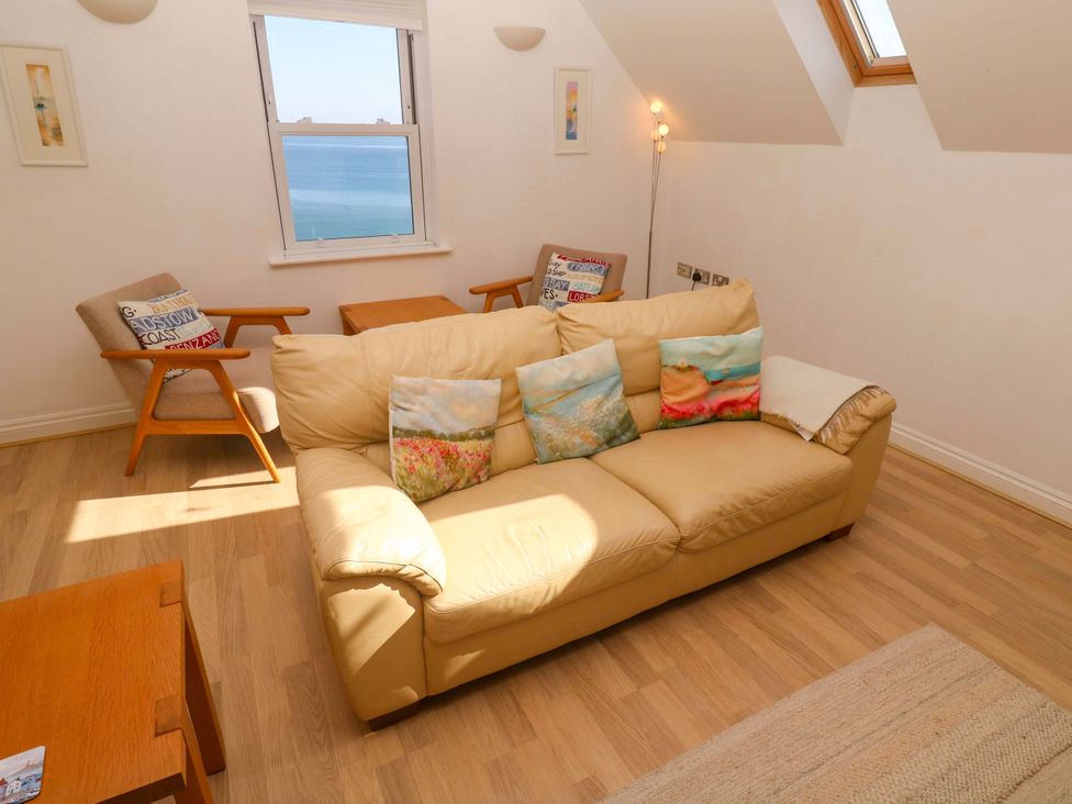 A living room with a sofa and armchair at Meridian in Carbis Bay