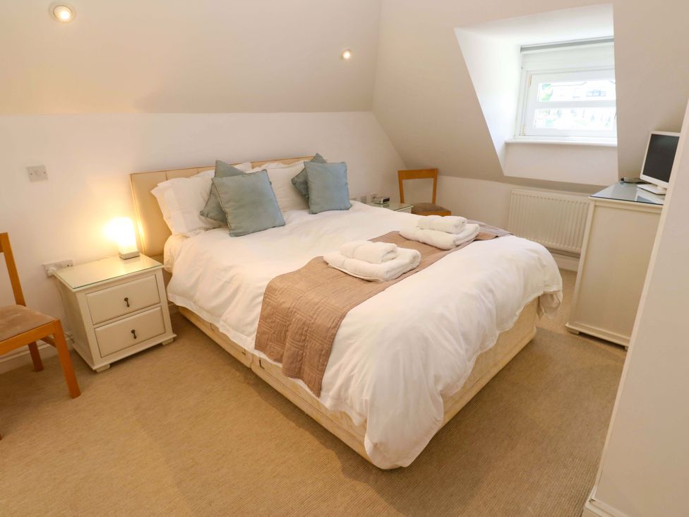 A bedroom with a bed and bedside table at Meridian in Carbis Bay