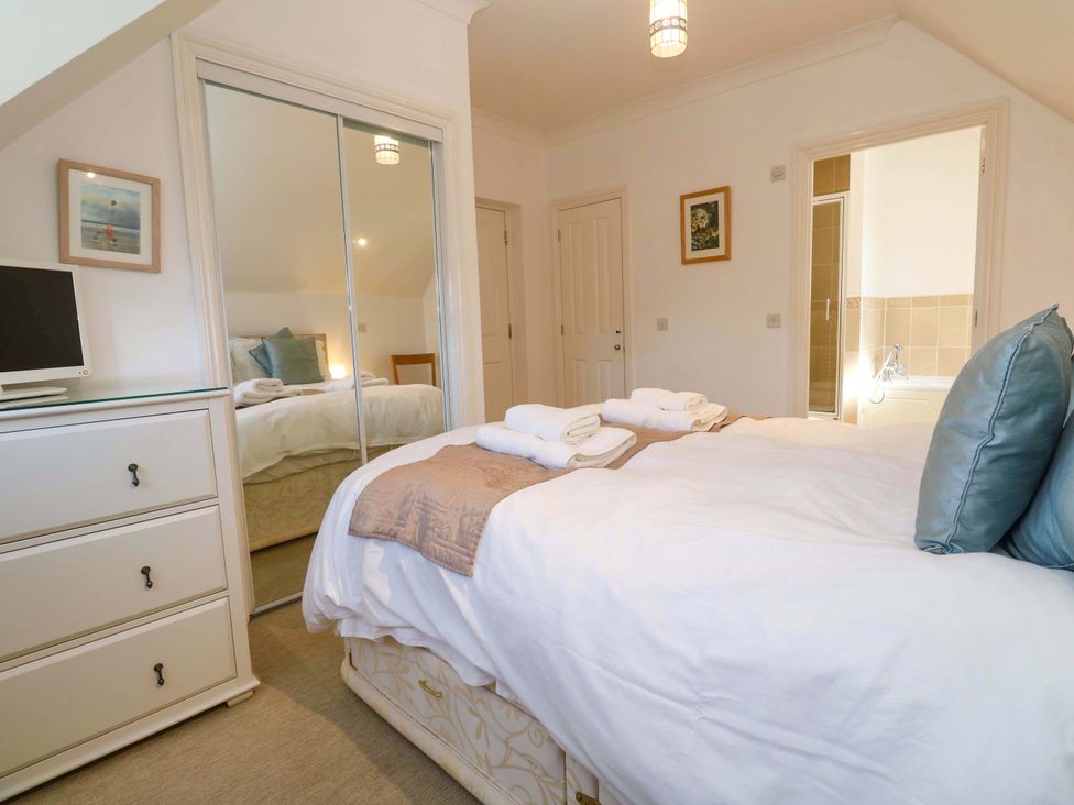 A bedroom with a bed and television at Meridian in Carbis Bay