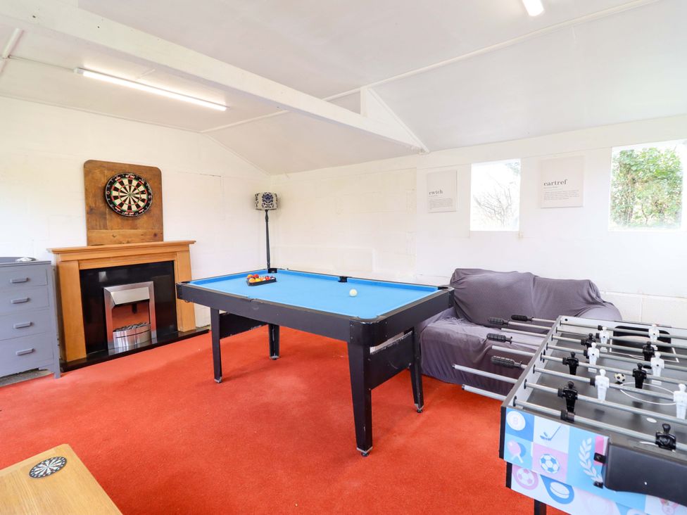 A games room with a pool table and foosball table at Glyn Morfa in Harlech