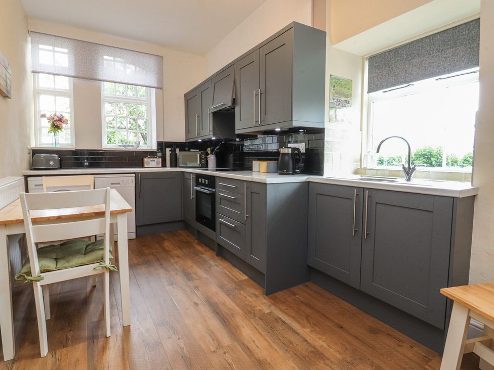 A kitchen with cabinets and appliances at Glebe Cottage in Broughton near Skipton