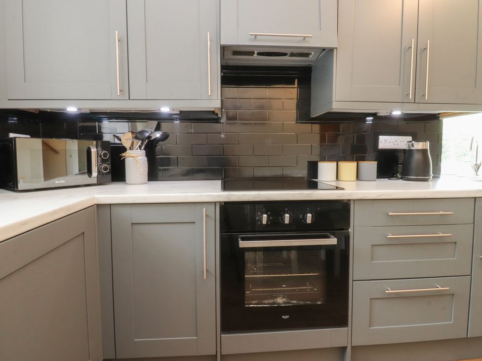 A kitchen with a microwave and oven at Glebe Cottage Broughton near Skipton