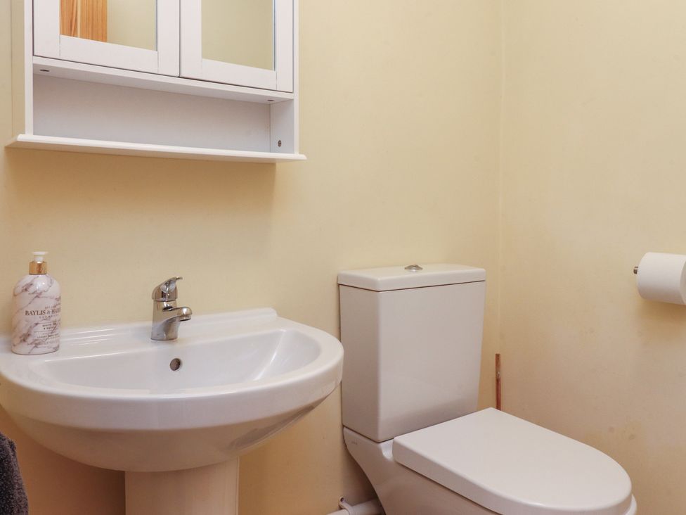 A bathroom with a sink and toilet at Glebe Cottage in Broughton near Skipton
