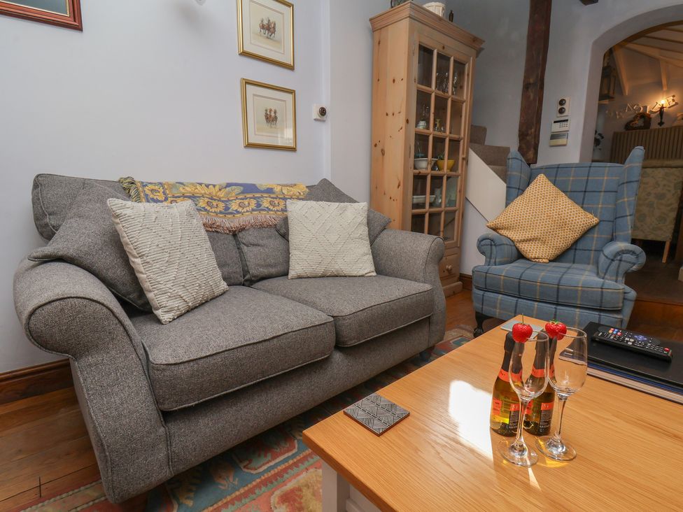 A living room with a sofa and coffee table at Cobbles House in Whitby