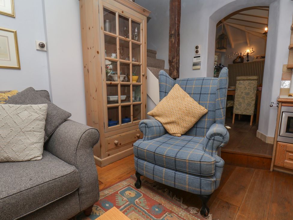 A living room with a sofa and armchair at Cobbles House in Whitby