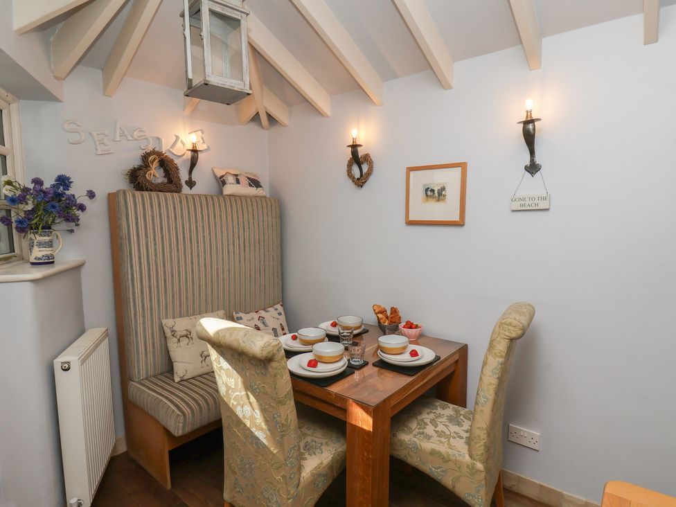 A dining room with a table and chairs at Cobbles House in Whitby