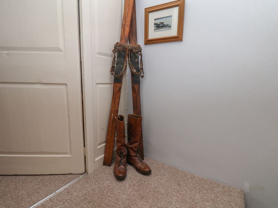 An entryway with boots and a framed picture at Cobbles House in Whitby