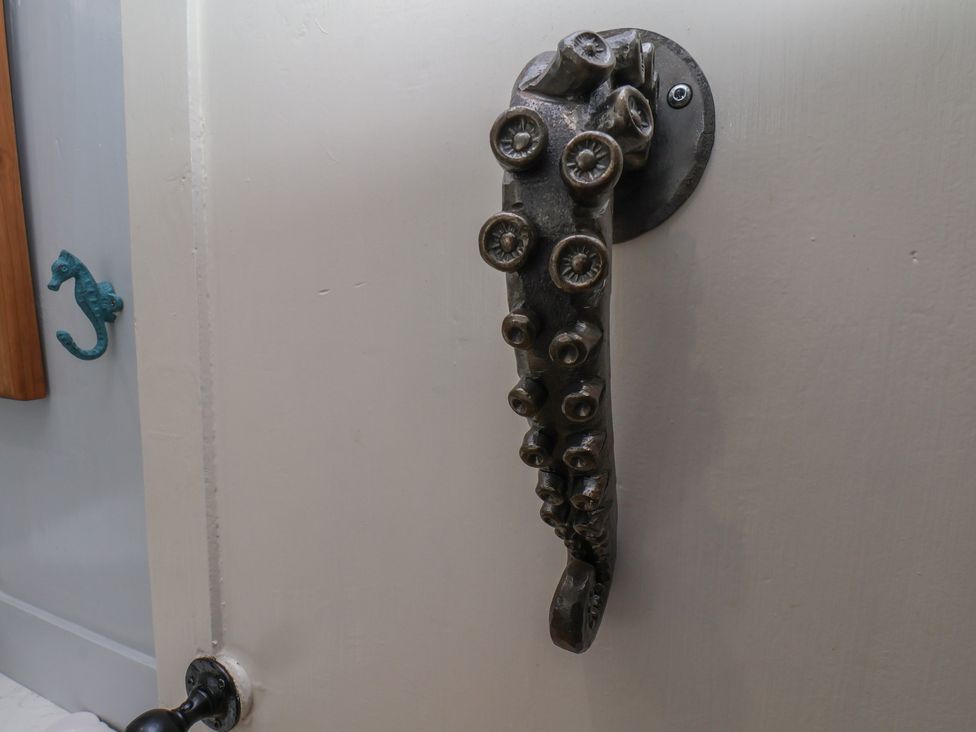 A door handle shaped like an octopus tentacle at Cobbles House in Whitby