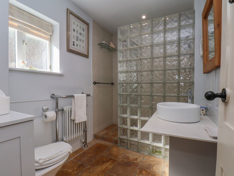 A bathroom with a shower and sink at Cobbles House in Whitby