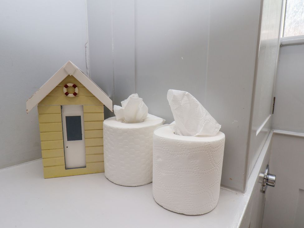 A tissue box and paper towels in a bathroom at Cobbles House Whitby