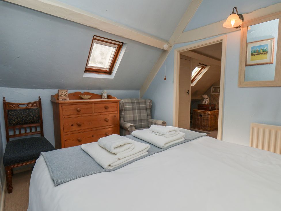 A bedroom with a bed and dresser at Cobbles House in Whitby
