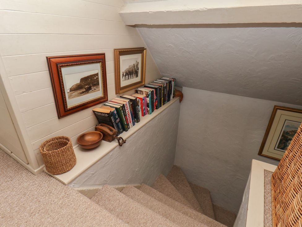 A stairwell with books and frames at Cobbles House in Whitby