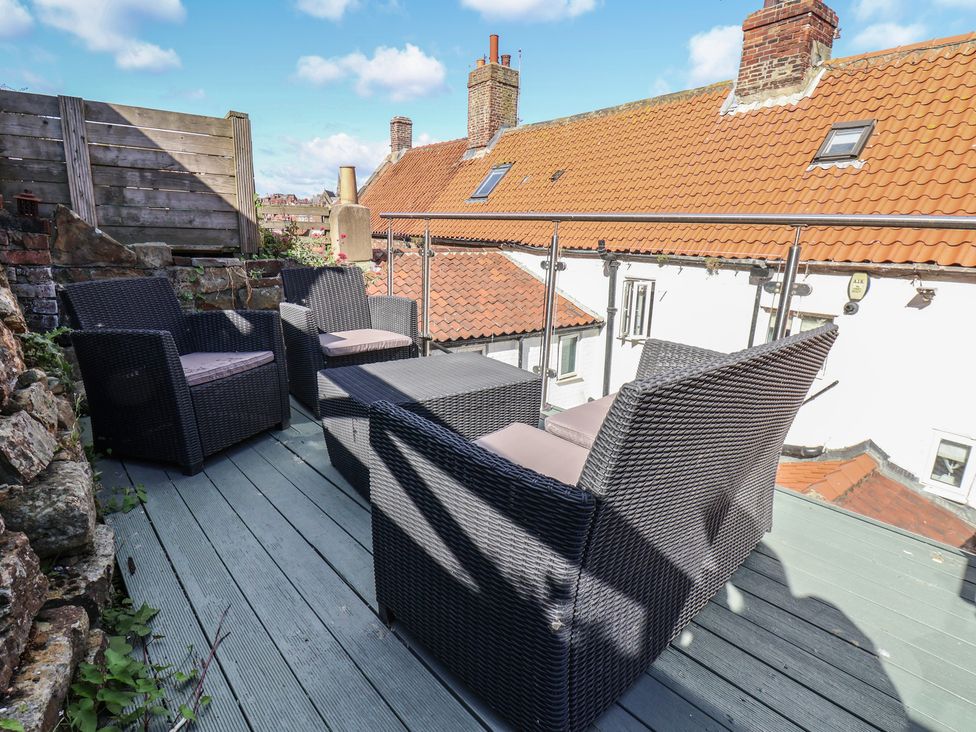 An outdoor seating arrangement on a terrace at Cobbles House in Whitby