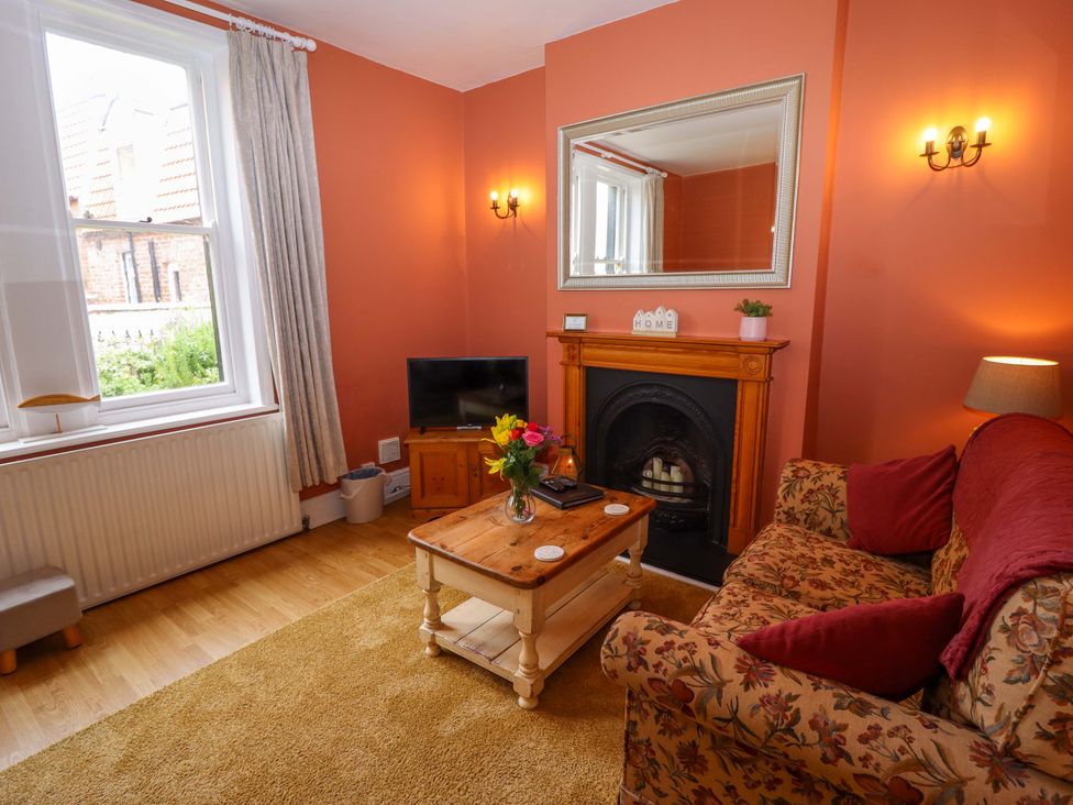 A living room with a sofa and television at West End House in Whitby