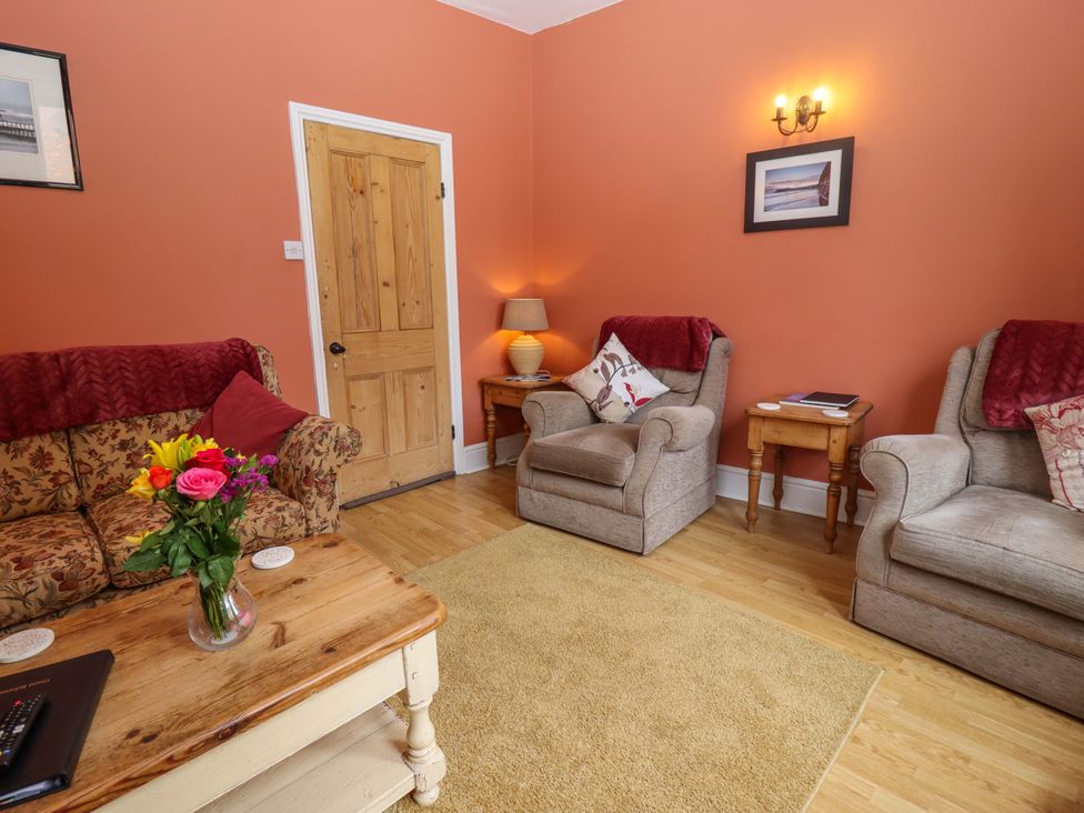 A living room with two armchairs and a coffee table at West End House in Whitby