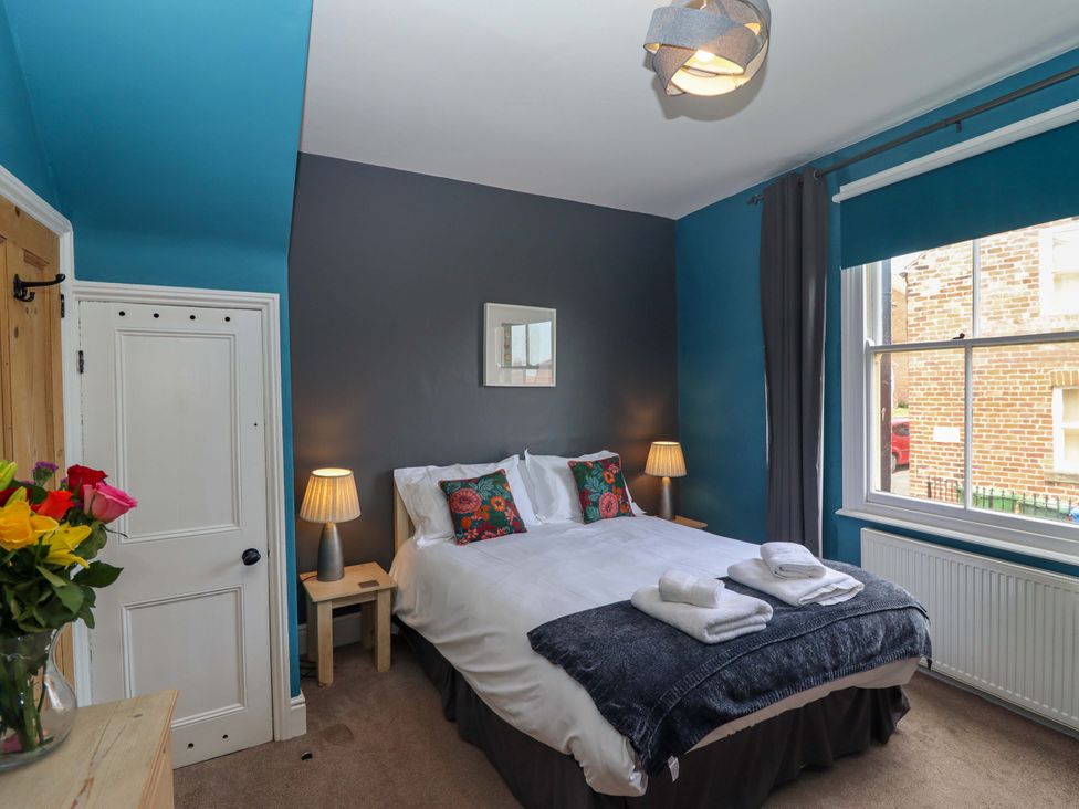 A bedroom with a bed and lamps at West End House in Whitby