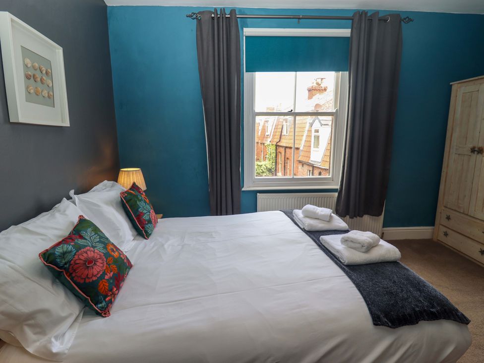 A bedroom with a bed and wardrobe at West End House in Whitby