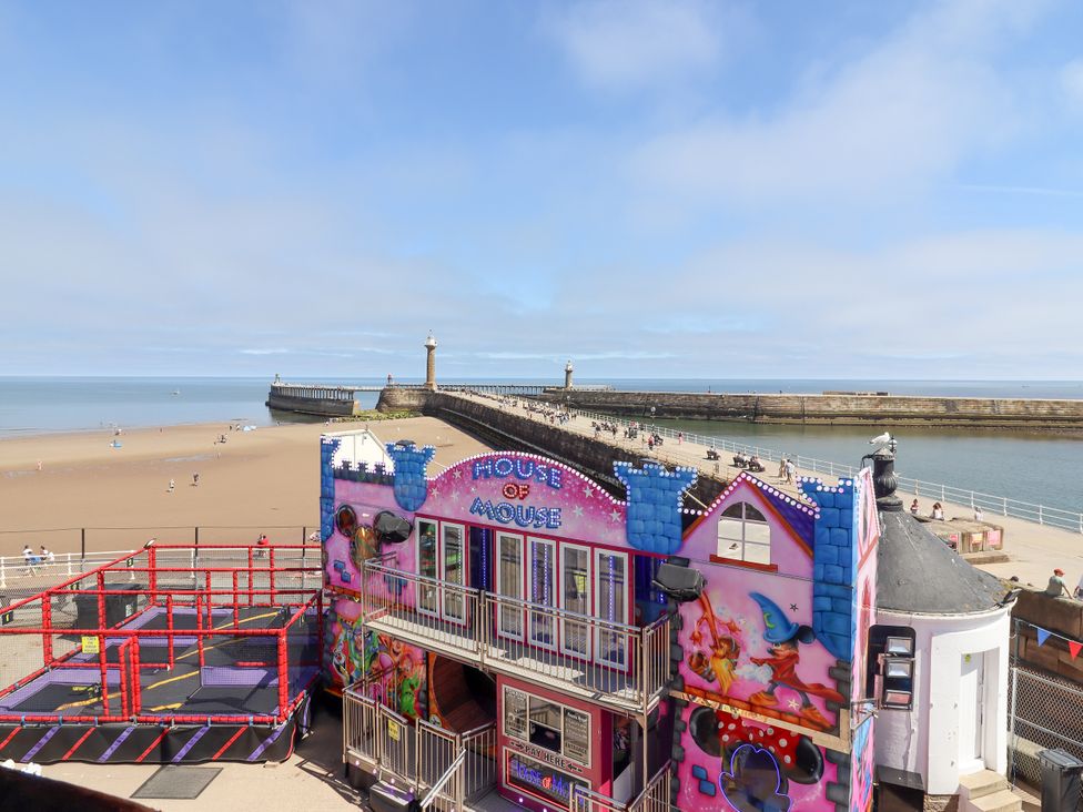 A beach with a house and pier at Beachfront Whitby