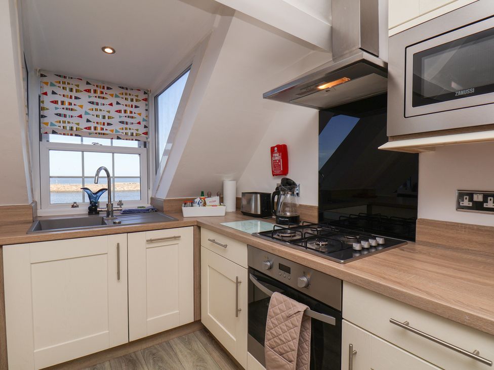 A kitchen with a sink and stove at Beachfront Whitby