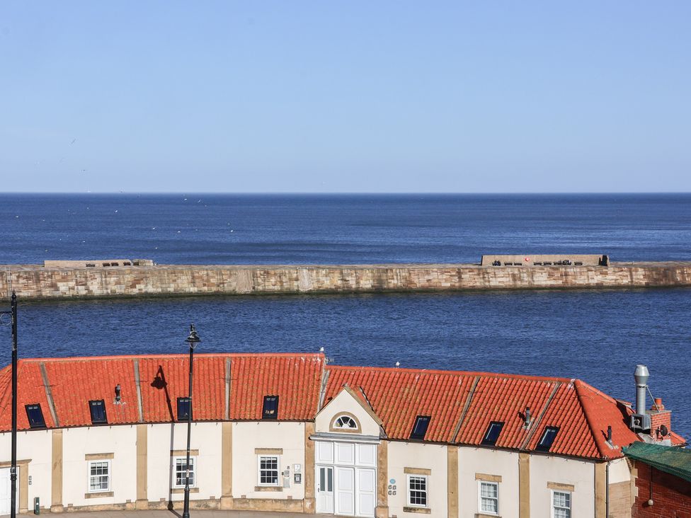 A view of the sea and pier from a building at Beachfront Whitby