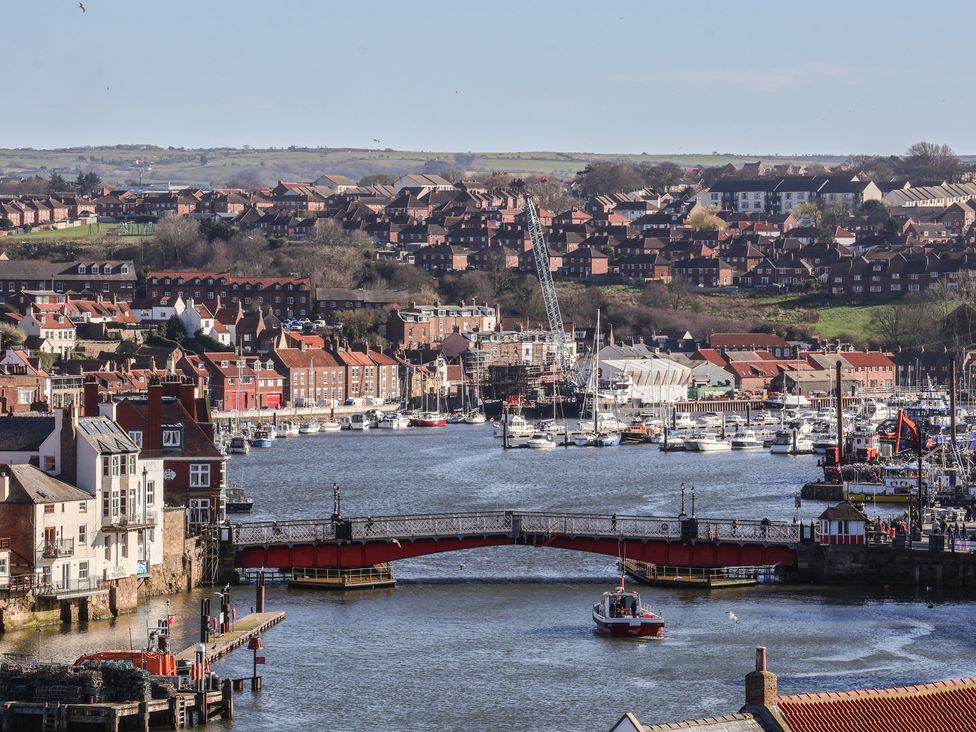 A view of a harbor with boats and houses at Beachfront in Whitby