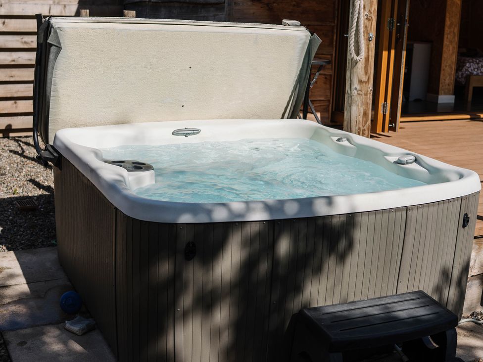A hot tub with a cover and steps at The Chard in Longtown