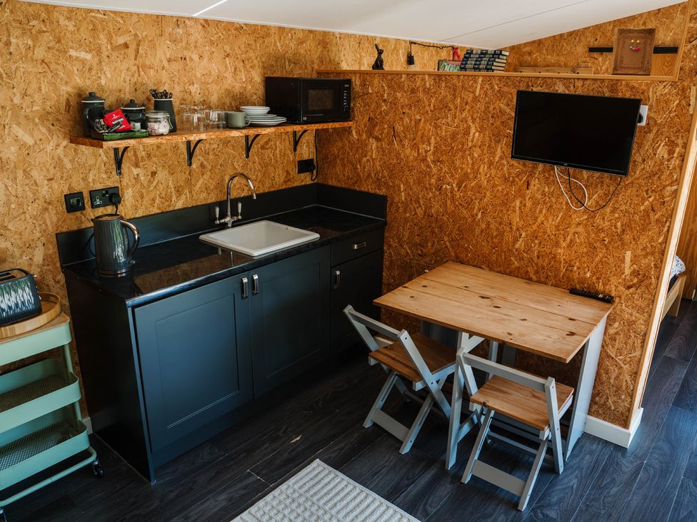 A kitchen with sink and microwave at The Chard in Longtown
