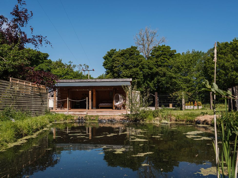 An outdoor area with a shed and a pond at The Chard in Longtown