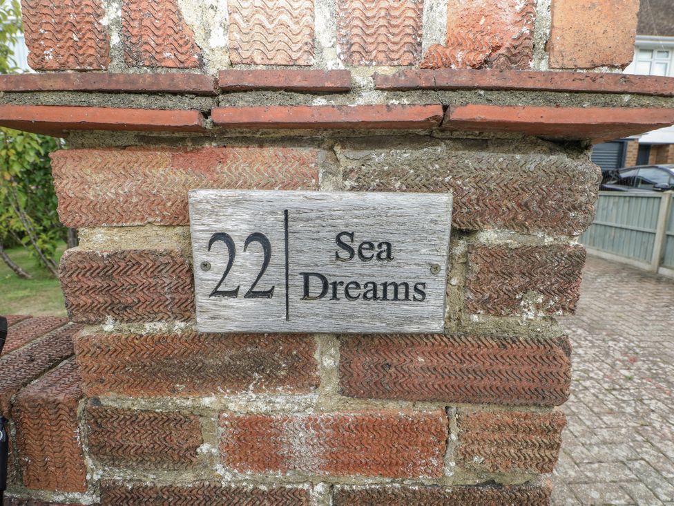 A nameplate indicating 22 Sea Dreams on a brick wall at Sea Dreams in Goring-By-Sea