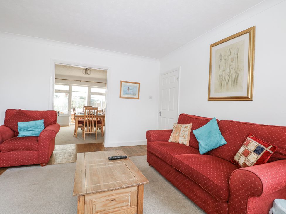 A living room with a coffee table and seating at Sea Dreams in Goring-By-Sea