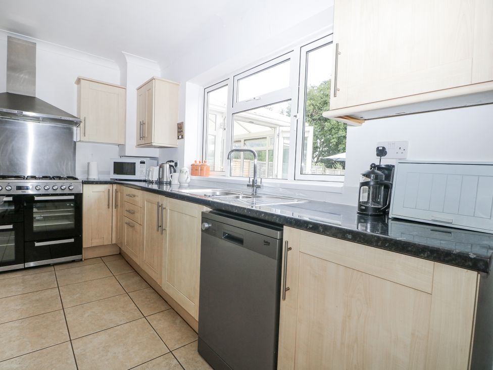 A kitchen with cabinets and appliances at Sea Dreams in Goring-By-Sea